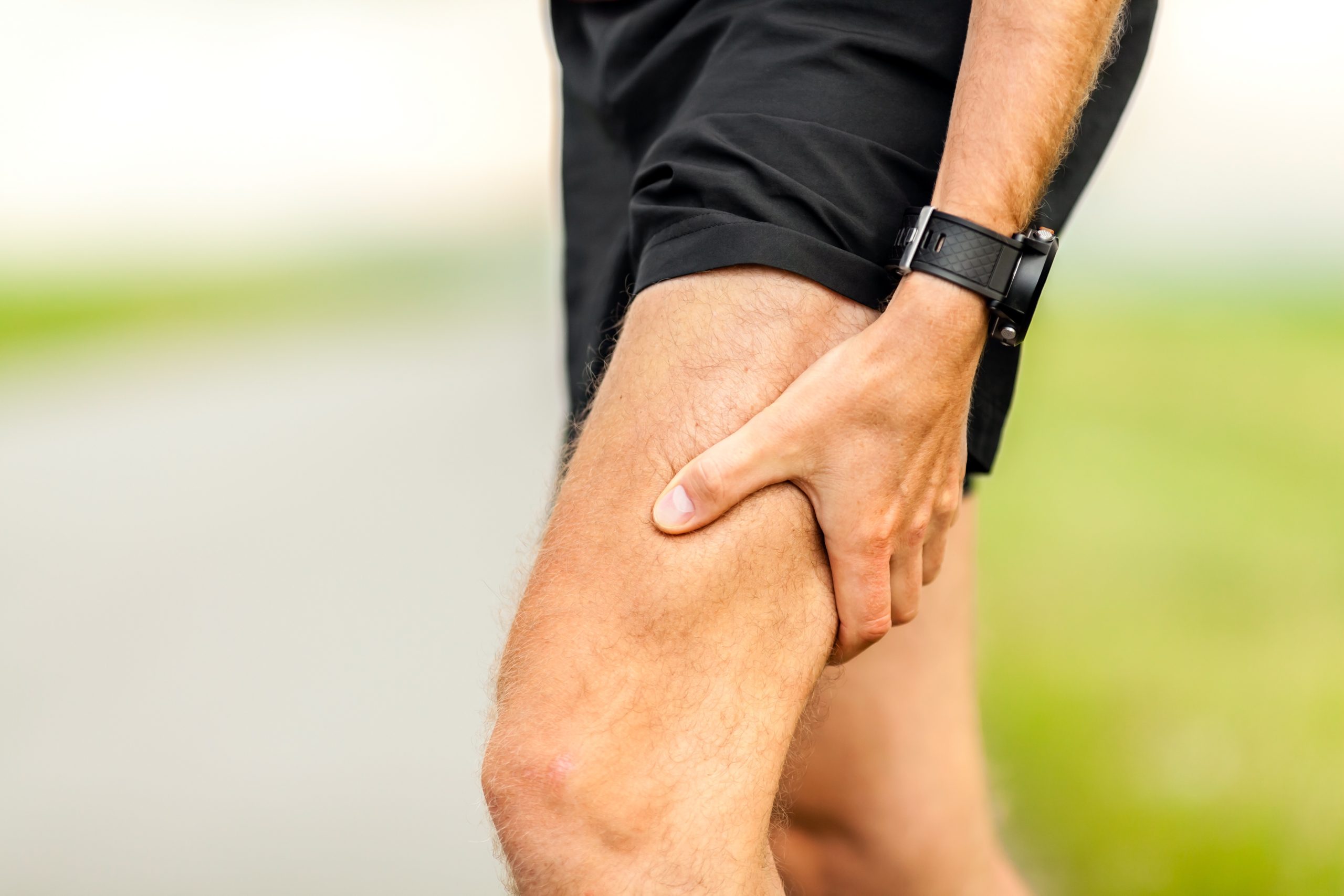 Runners leg and muscle pain on running training outdoors in summer nature, sport jogging physical injury when working out. Health and fitness concept with sore body